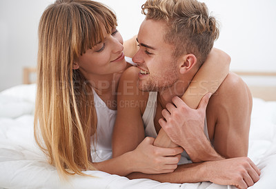 Buy stock photo Couple, love and embrace in bed on weekend, relax and bonding or care in relationship at home. Happy people, loyalty and commitment to marriage in bedroom, smiling and romance or comfortable in hug