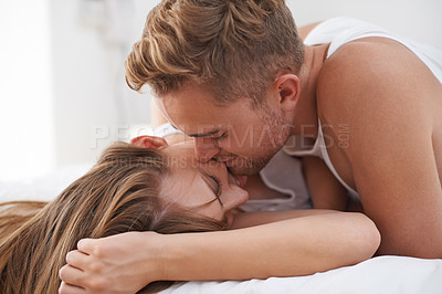 Buy stock photo Couple, morning and bed in love with kiss and happy together in marriage. Weekend, getaway and bonding in house with care and lovers cuddle for affection and partners with commitment in apartment