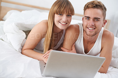 Buy stock photo Happy couple, portrait and relax on laptop in bed to watch movies with subscription for streaming in home. Smile, man and woman in bedroom with computer for website, blog or social media on internet