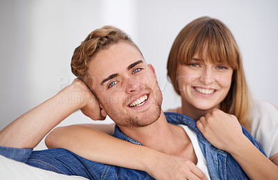 Buy stock photo Happy, couple and couch with closeup portrait in home, hug and together in living room for happiness. Young, woman and man with smile on sofa in house for love, lounge and peaceful environment

