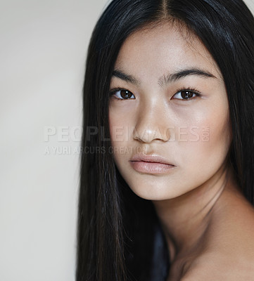 Buy stock photo Studio shot of a beautiful young woman posing against a gray background