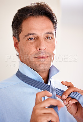 Buy stock photo A mature businessman getting ready for work in the morning