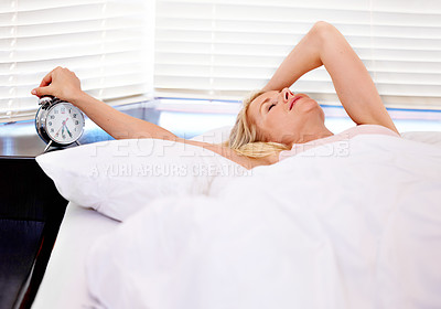 Buy stock photo Woman, alarm clock and stress for waking up in bed, tired and sleepless or fatigue at home. Female person, exhausted and pressing or hit snooze in apartment, frustrated and depression or lazy and sad