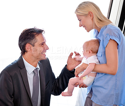 Buy stock photo Love, father and greeting mother and baby after a long day at work. Happy businessman, excited and smile or bonding with family or relax together at home with parents and child with affection