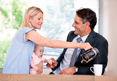Buy stock photo Kitchen, coffee and happy parents with baby, man and father with love for family in morning for work. Marriage, woman and person ready for job, professional and bonding with child and wife in house