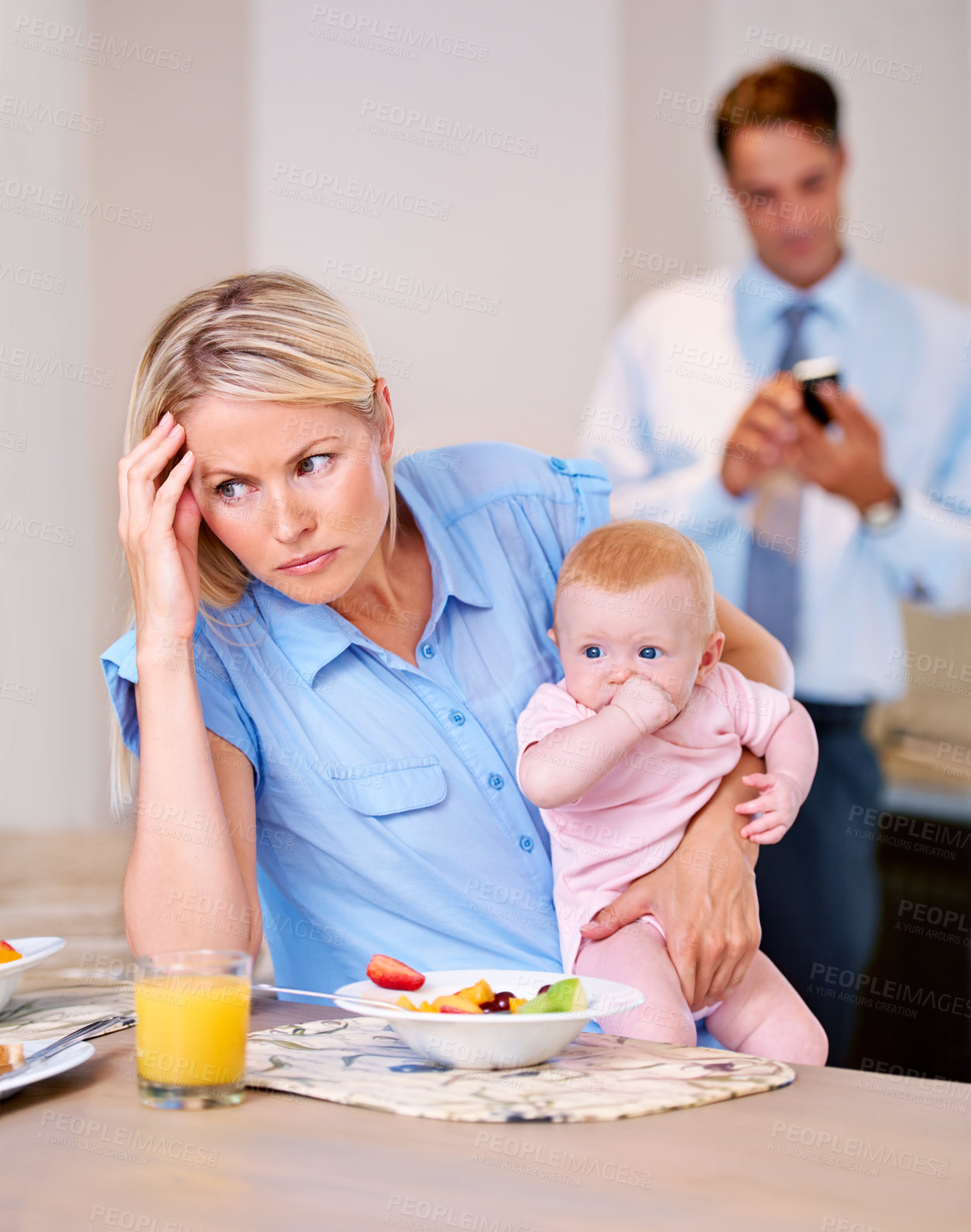Buy stock photo Young mother looking stressed while husband gets ready for work
