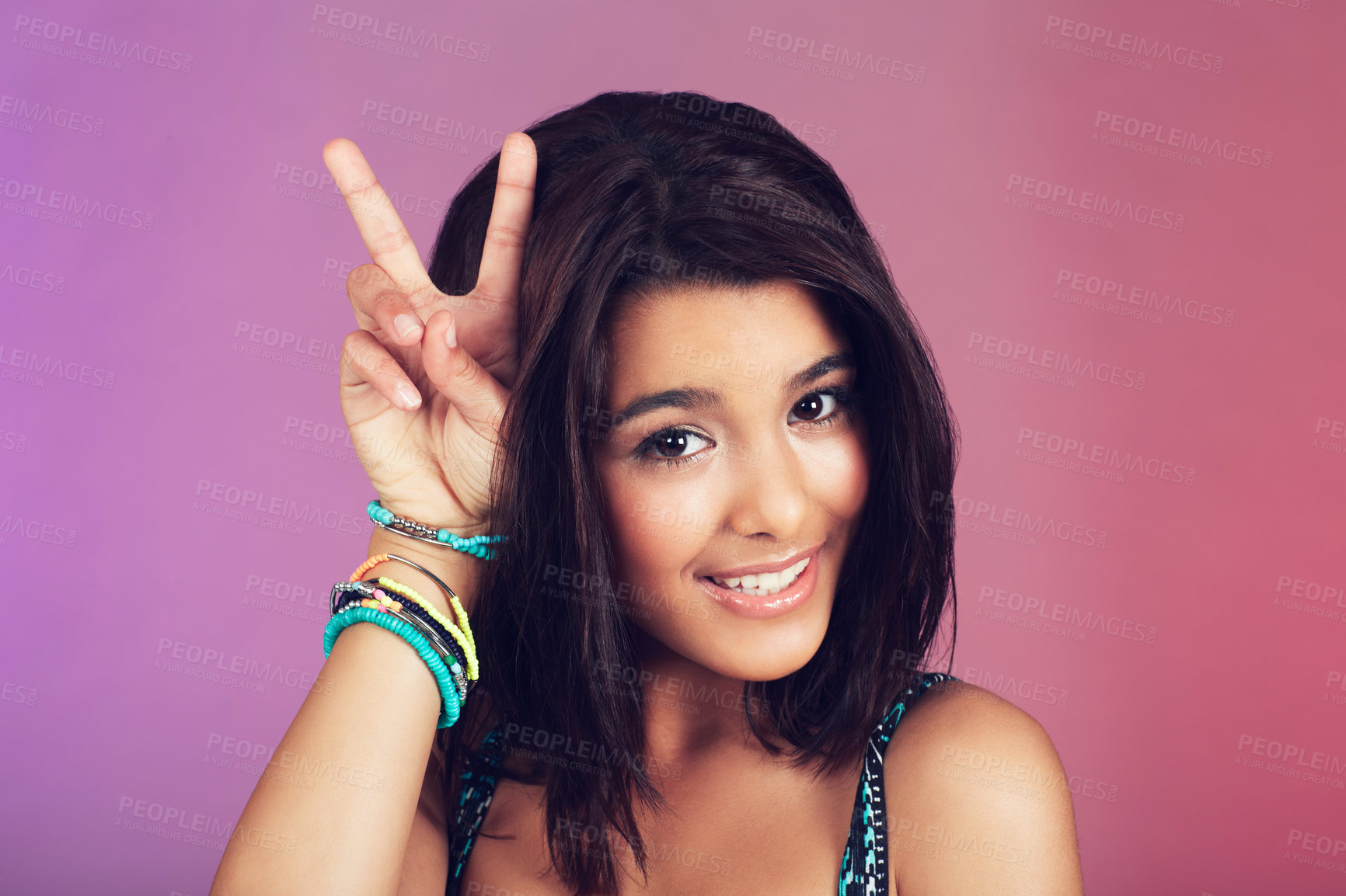 Buy stock photo Studio, woman and portrait with closeup, peace sign and beauty with smile, confidence and face. Latino teen, happy and purple background with cool, bracelet and hipster for youth, color and style 