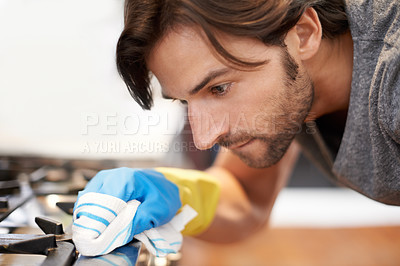 Buy stock photo Shot of a young man cleaning his house
