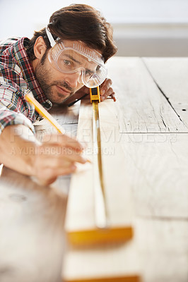 Buy stock photo Wood, carpenter man building project and measurement with tape at construction site. Home renovation or furniture design, handyman working on maintenance at workshop and woodwork or handcraft 