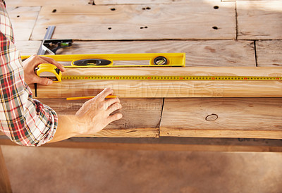 Buy stock photo A handyman getting his measurements just perfect with a spirit level and measuring tape