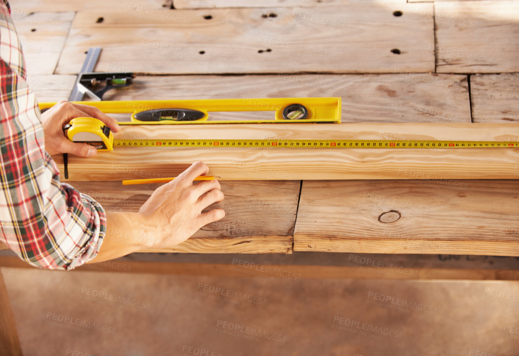 Buy stock photo A handyman getting his measurements just perfect with a spirit level and measuring tape