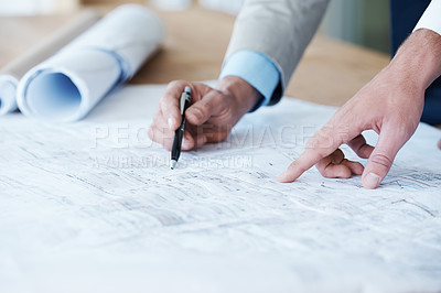 Buy stock photo Close up of architects going over the building plans