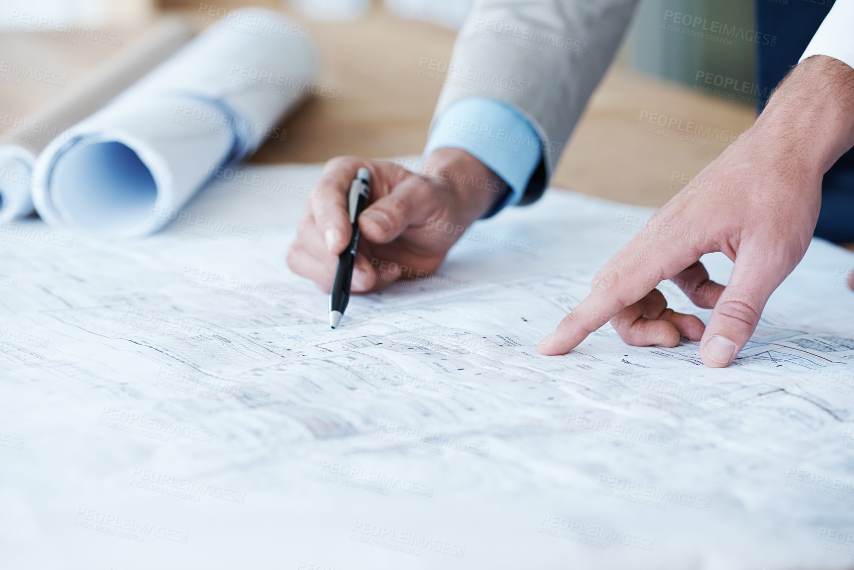 Buy stock photo Close up of architects going over the building plans