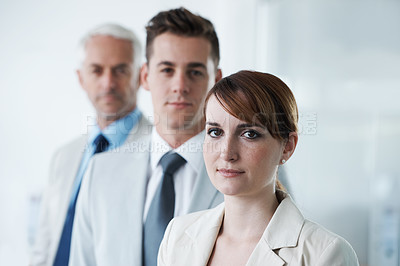 Buy stock photo Portrait of three corporate business people , standing in a row and in broad room. Smiling friendly group of three business partners of different age private company staff posing for office 