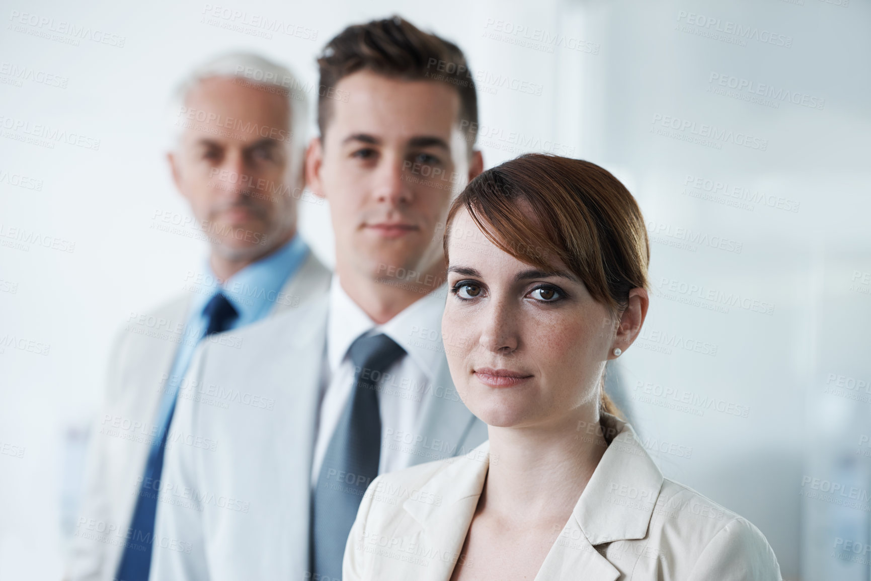 Buy stock photo Portrait of three corporate business people , standing in a row and in broad room. Smiling friendly group of three business partners of different age private company staff posing for office 