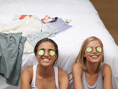 Buy stock photo Women, spa and friends in bedroom, smile and self care on bed together. Sisters, cucumber and wellness connect for home, relaxation and beauty talk for happiness, skincare and antioxidant treatment