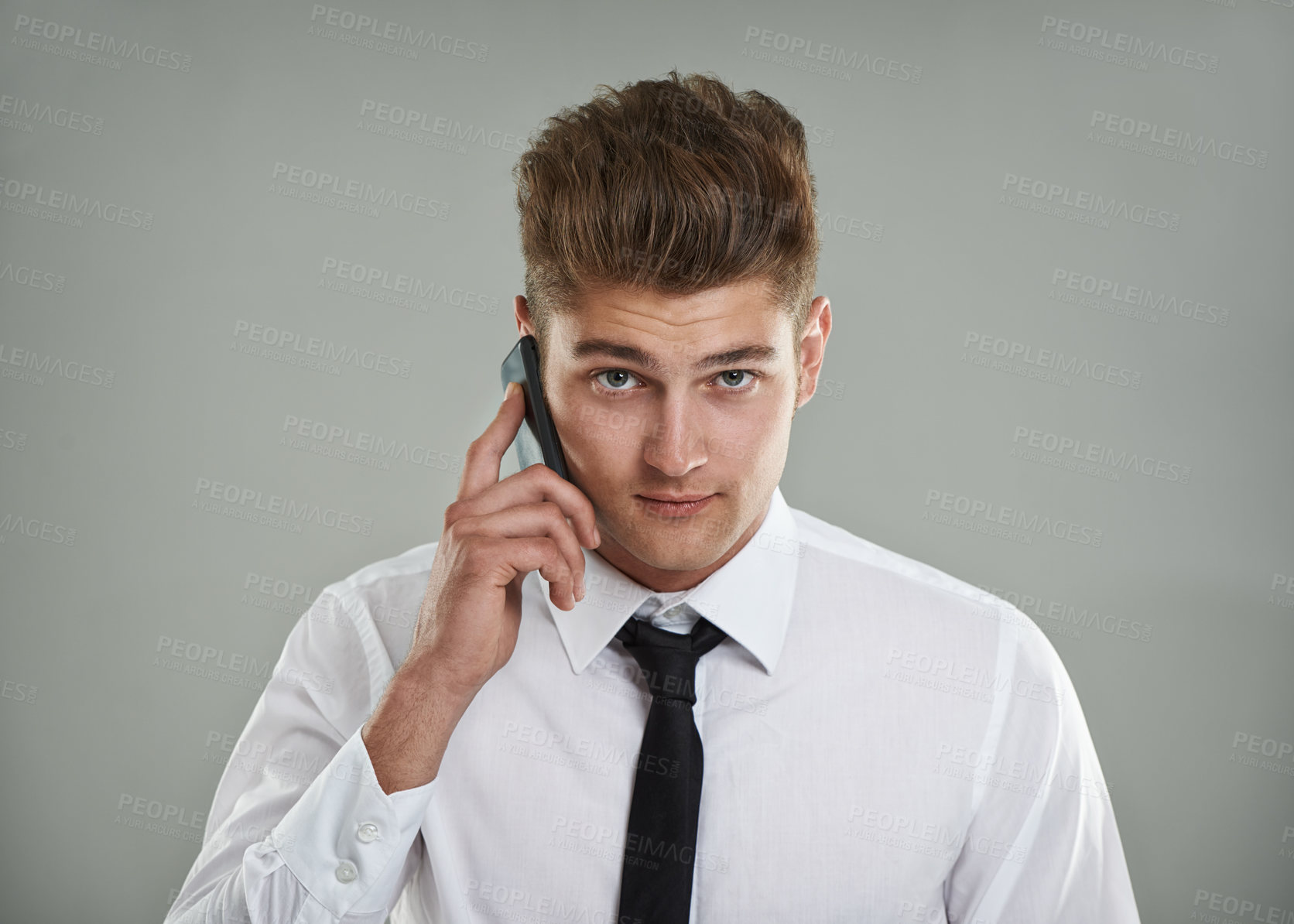 Buy stock photo Portrait, studio and man with phone call while meeting sales targets and KPI with gray background. Professional salesman, financial advisor or smartphone with shirt, tie or trendy haircut for mockup