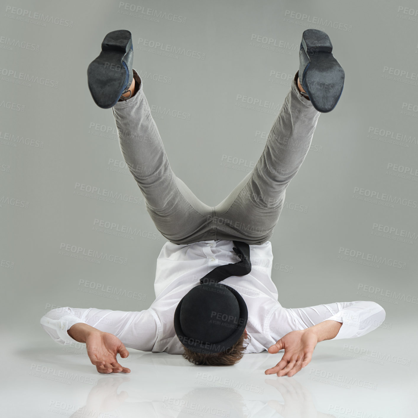 Buy stock photo A young businessman doing a trick with a hat