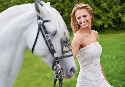 Buy stock photo Wedding, woman and happy with horse outdoor on grass for celebration, marriage or confidence in countryside. Bride, person and stallion on lawn in field with smile, dress or animal at event in nature