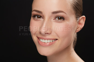 Buy stock photo Cropped view of a naturally beautiful young brunette smiling against a black background