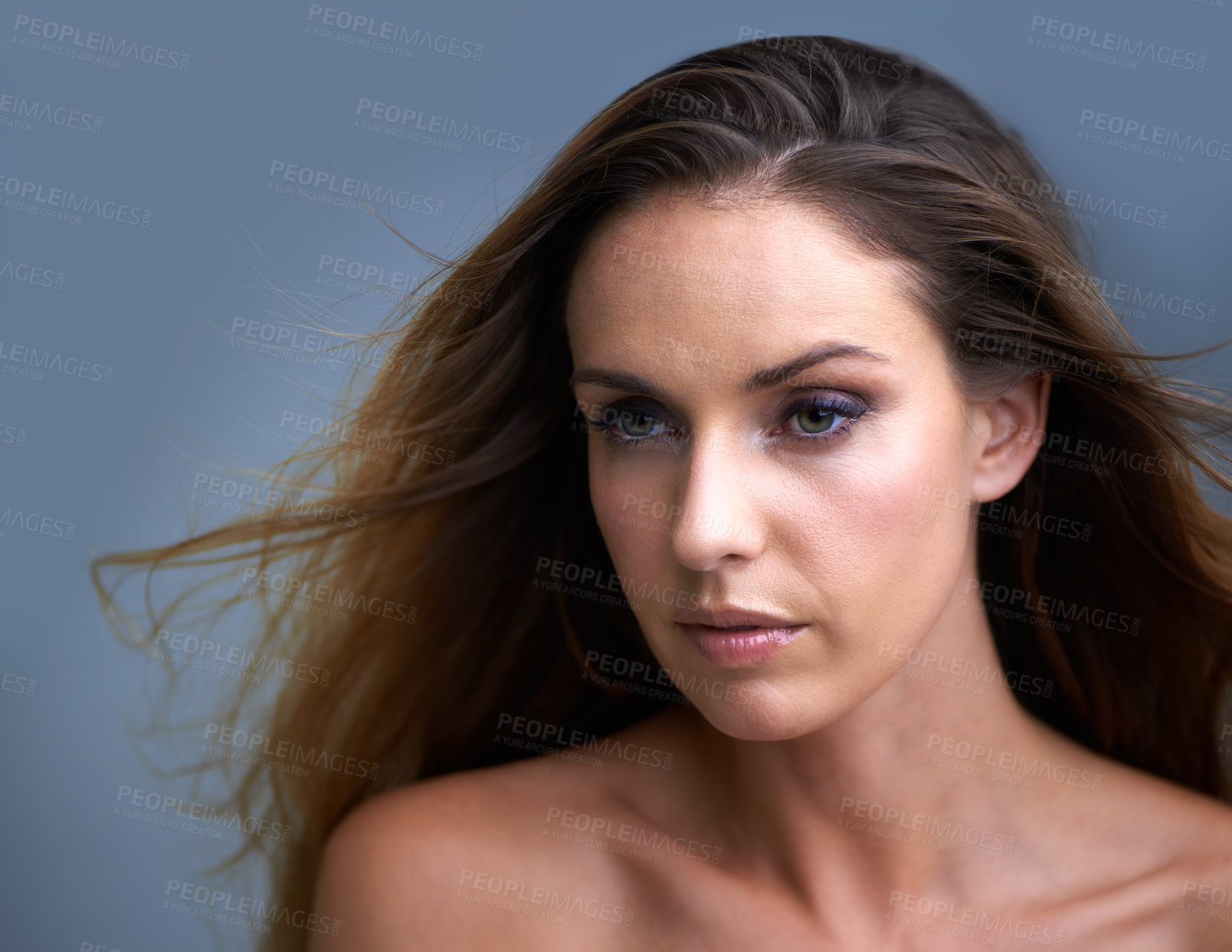 Buy stock photo Woman, face and beauty with makeup, cosmetics or skincare on a blue studio background. Attractive female person, brunette or model with eye liner, shadow or skin tone for facial treatment on mockup