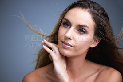 Buy stock photo Woman, face and natural beauty in skincare, cosmetics or makeup on a blue studio background. Happy or attractive female person, brunette or model with smile for haircare or facial treatment on mockup