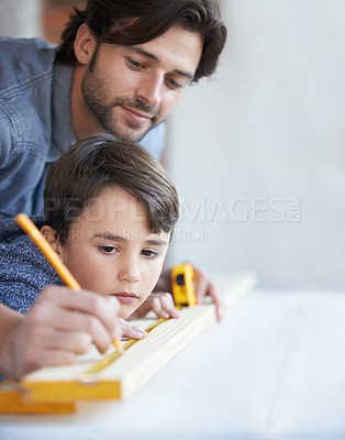 Buy stock photo Father, son and woodwork or teaching construction with measuring tape or development, bonding or home repairs. Male person, child and parenting for carpenter learning or furniture, lesson or building