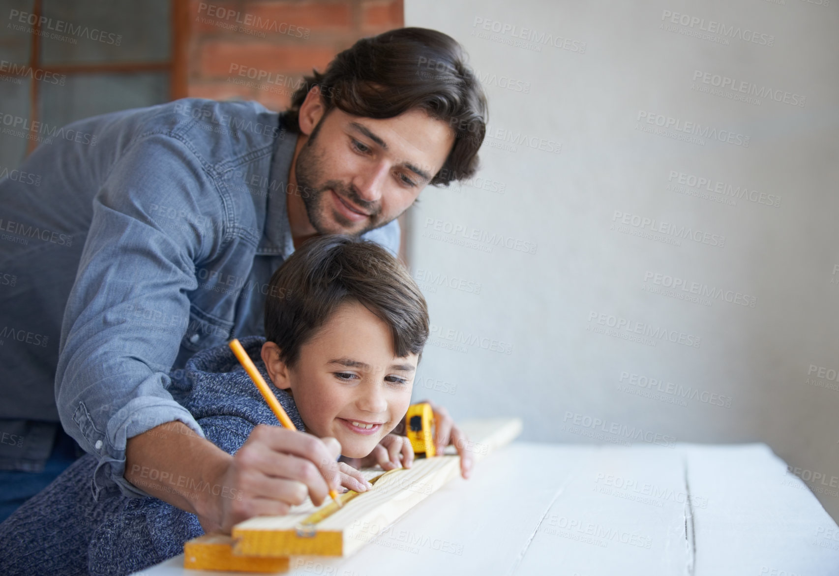 Buy stock photo A father and son doing woodwork together