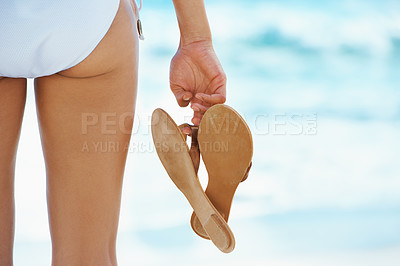 Buy stock photo Woman, beach and flip flops at closeup with back for summer, holiday and fashion in sunshine. Person, bikini and shoes for style, clothes or swimwear on vacation by ocean, sea and waves in Indonesia