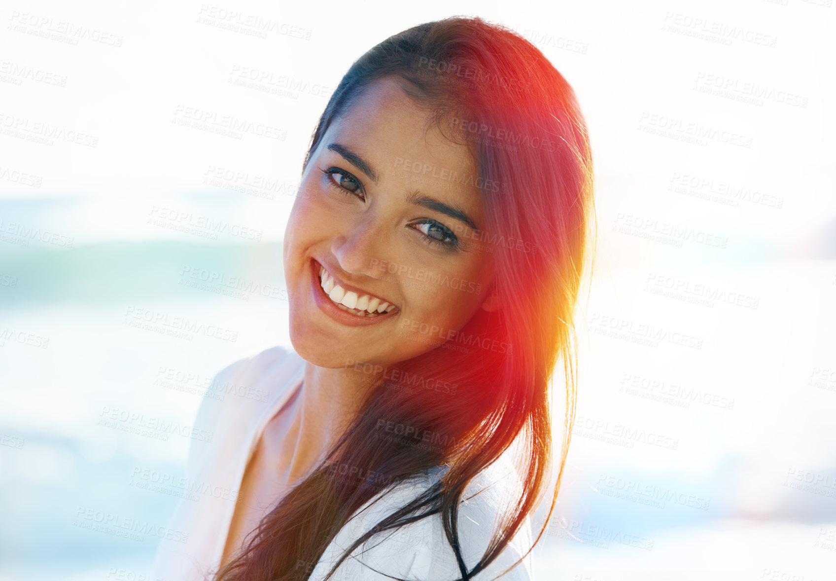 Buy stock photo Indian female person, beach and smile for ocean, waves and breeze for summertime in Bali for vacation. Woman, sea and holiday relaxation abroad with lens flare, sand and happy for memories and trip