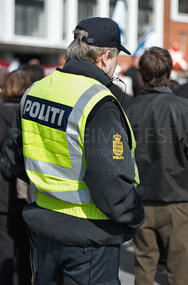 Buy stock photo Safety, protection and security with police officer in city for peace, law enforcement and authority. Emergency services, justice and guard with person in street for help, order and arrest
