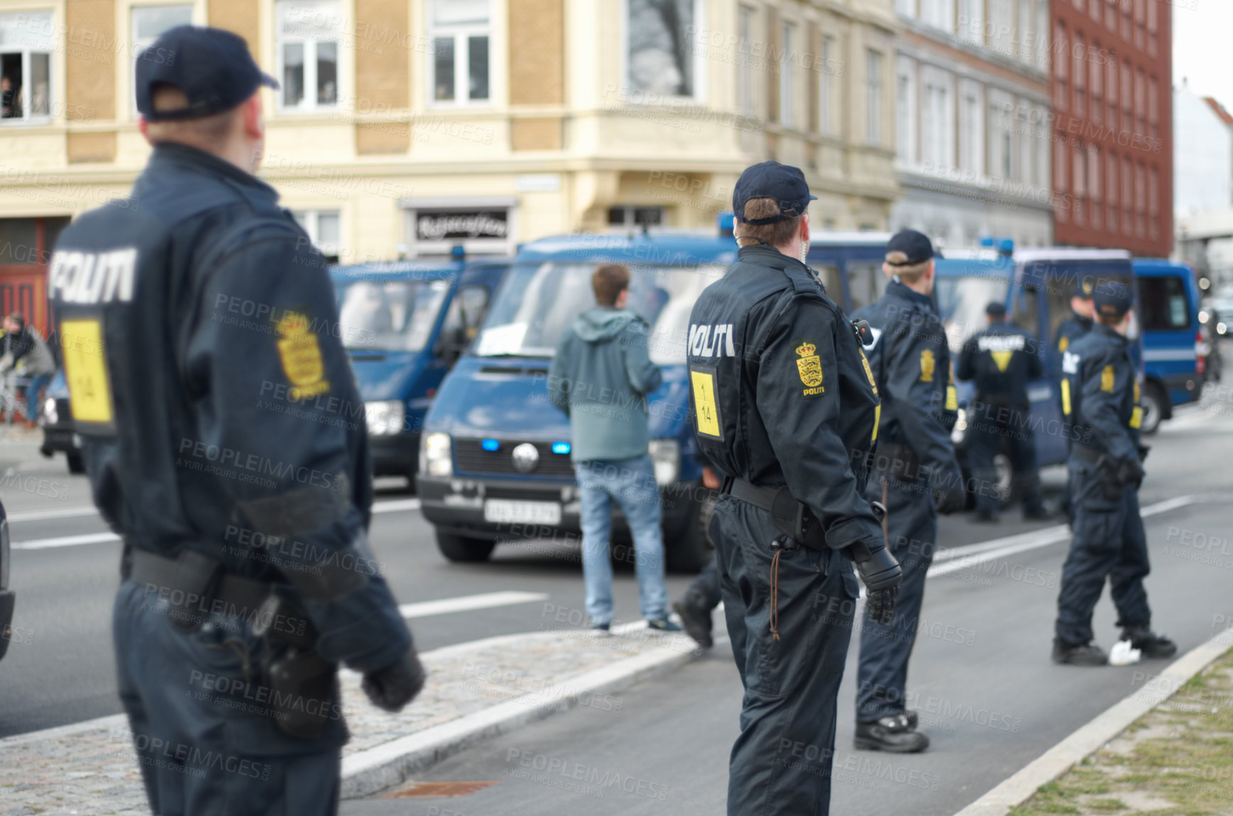 Buy stock photo Police officer, group and patrol in street for crowd safety with protection service for public in city. People, law enforcement and justice in danger, arrest or warning on urban road in Copenhagen