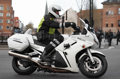 Buy stock photo Police, motorcycle and safety officer working for protection and peace in an urban neighborhood in the UK. Security, law and legal professional or policeman on a motorbike ready for service