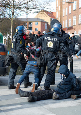 Buy stock photo Police men, criminal and arrest in the city of Denmark for street safety, security or law enforcement. Group of legal government officers arresting people in a urban town for crime, justice or riot