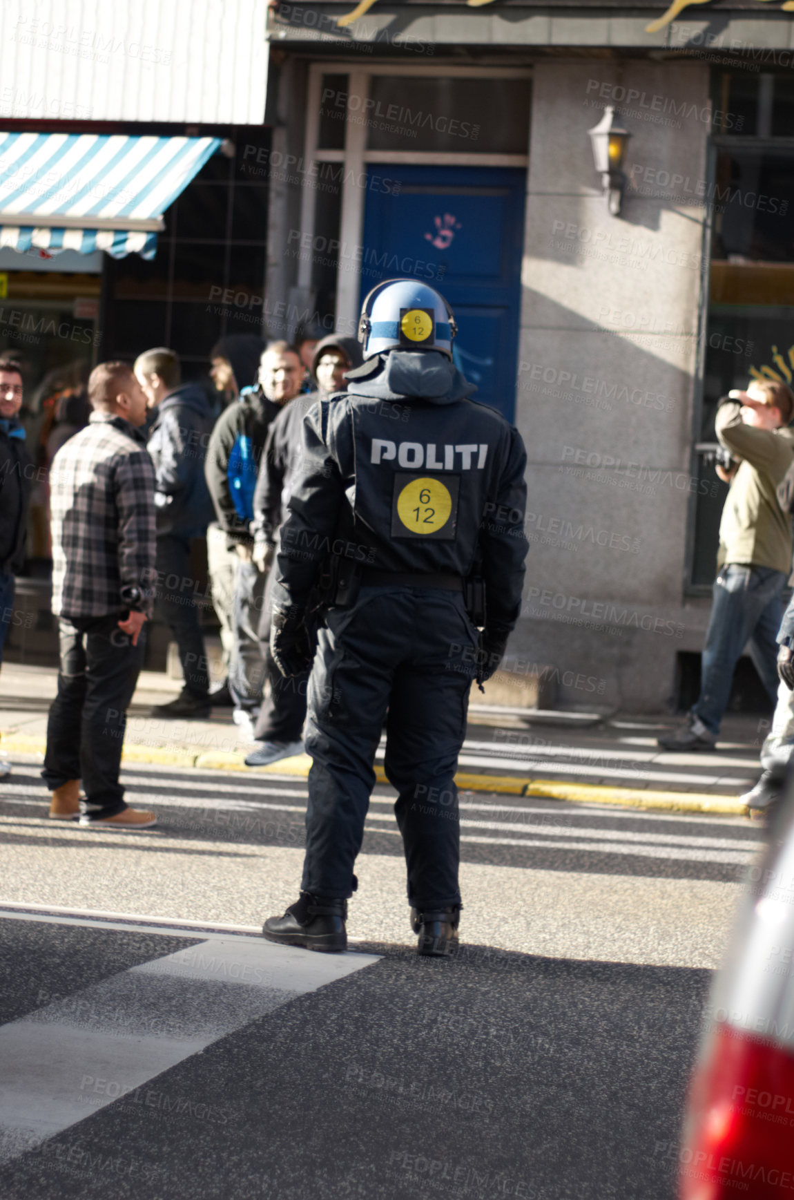 Buy stock photo Safety, crowd control and protest with police officer in city for law enforcement, protection or security. Brave, uniform and riot with person in Denmark street for rally, human rights or activist