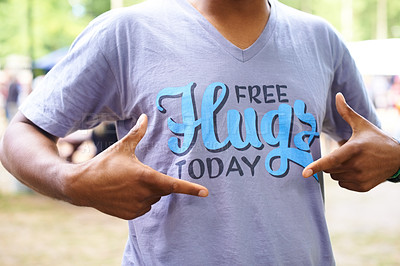 Buy stock photo Tshirt, outdoor and man with fun, pointing and free hugs today with party and promotion. Motivational slogan, person and guy with casual outfit and stylish clothes with sunshine and summer break