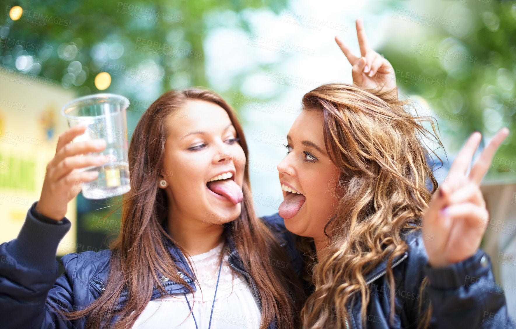 Buy stock photo Two friends having fun at a festival