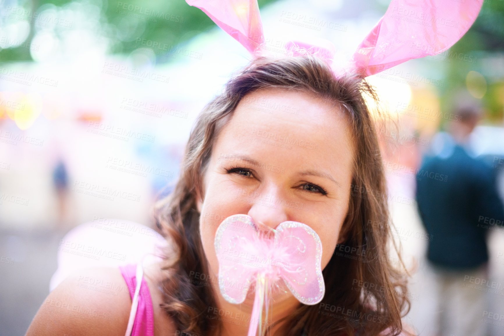 Buy stock photo Portrait, outdoor and woman with bunny ears, costume and party with fun and social gathering. Face, person and girl with sunshine and weekend break with happiness and funky clothes with silly outfit