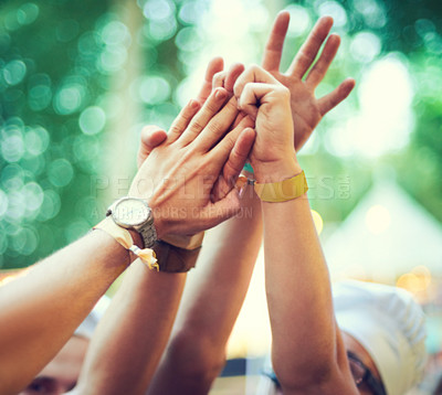 Buy stock photo Closeup, hands together and group at event, music festival and outdoor for fun, bonding and collaboration. Zoom, hand and people outside, partying and celebration with social gathering and concert