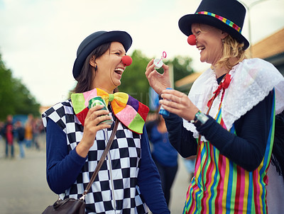Buy stock photo Clown, people and outdoor at festival, carnival or costume for event or concert in park. Happy, women and smile in funny props, clothes and dress up for culture, party in summer or holiday bubbles