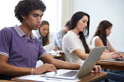 Buy stock photo University, laptop and man in classroom typing with research, learning and future opportunity. Education, knowledge and computer with group of students in college lecture studying for online exam.