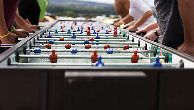 Buy stock photo Cropped shot of a group of people playing foosball
