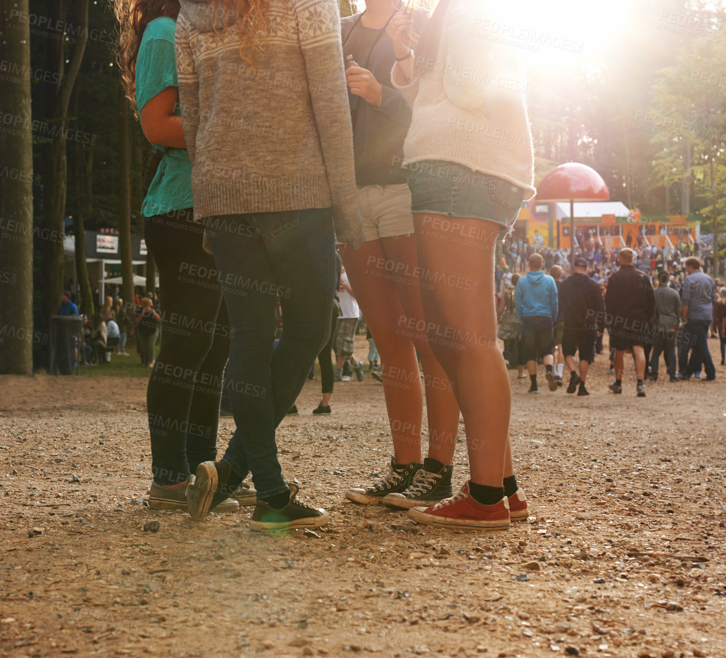 Buy stock photo Legs, forest and group of friends at festival together for social event, party or summer celebration. Flare, crowd and people in woods for talking, bonding or free time in nature with audience