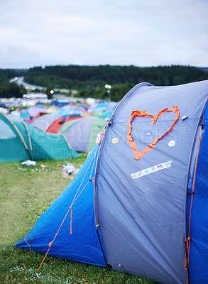 Buy stock photo Camping, festival and heart on tent at evening outdoor for event, party or celebration in nature. Field, forest or grass with shelter from weather on sky at campsite for adventure or getaway