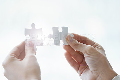 Buy stock photo Cropped shot a businessman holding two puzzle pices