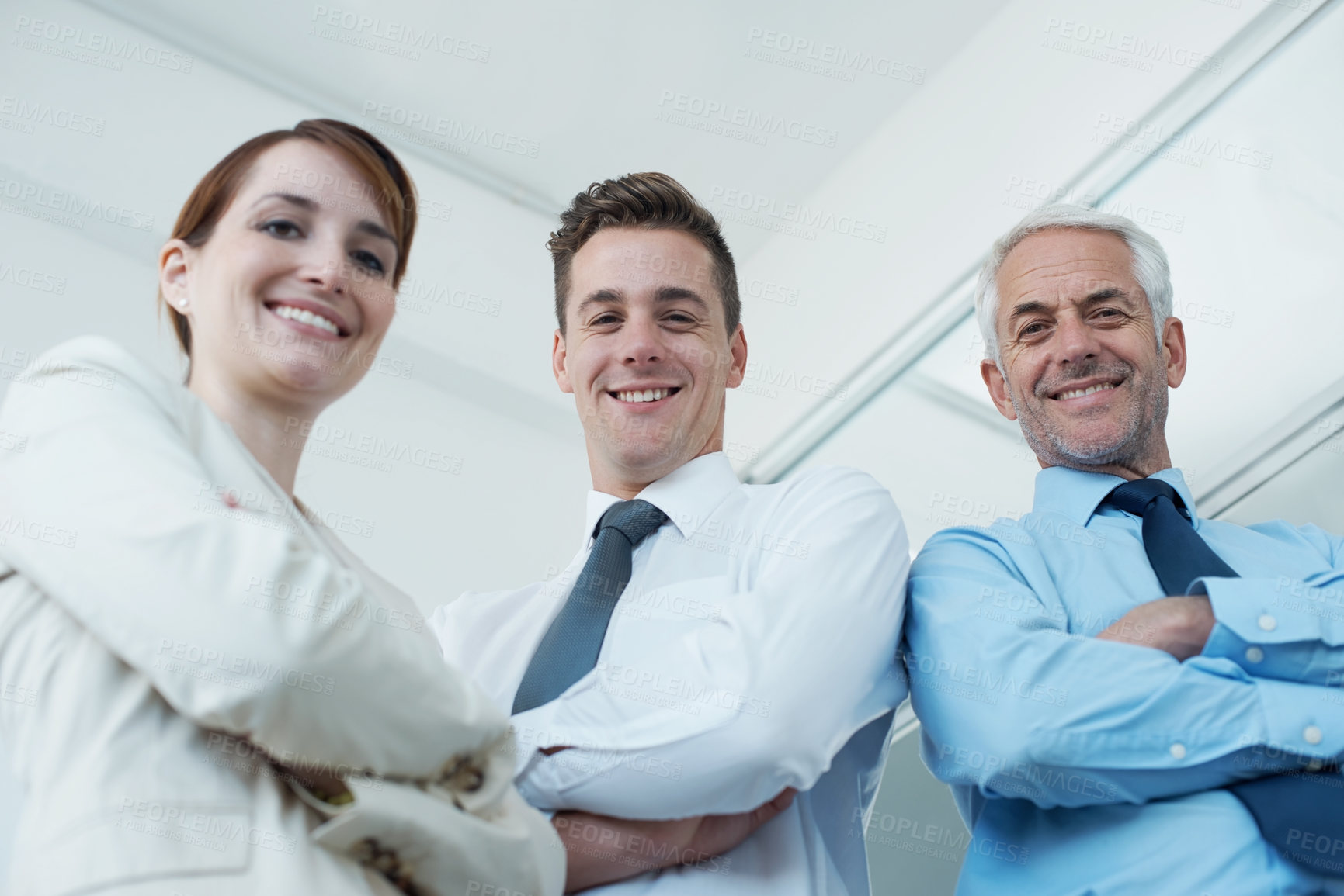 Buy stock photo Happy, crossed arms and portrait of business people in office with positive, good and confident attitude. Smile, pride and team of lawyers in meeting for collaboration in workplace from below.