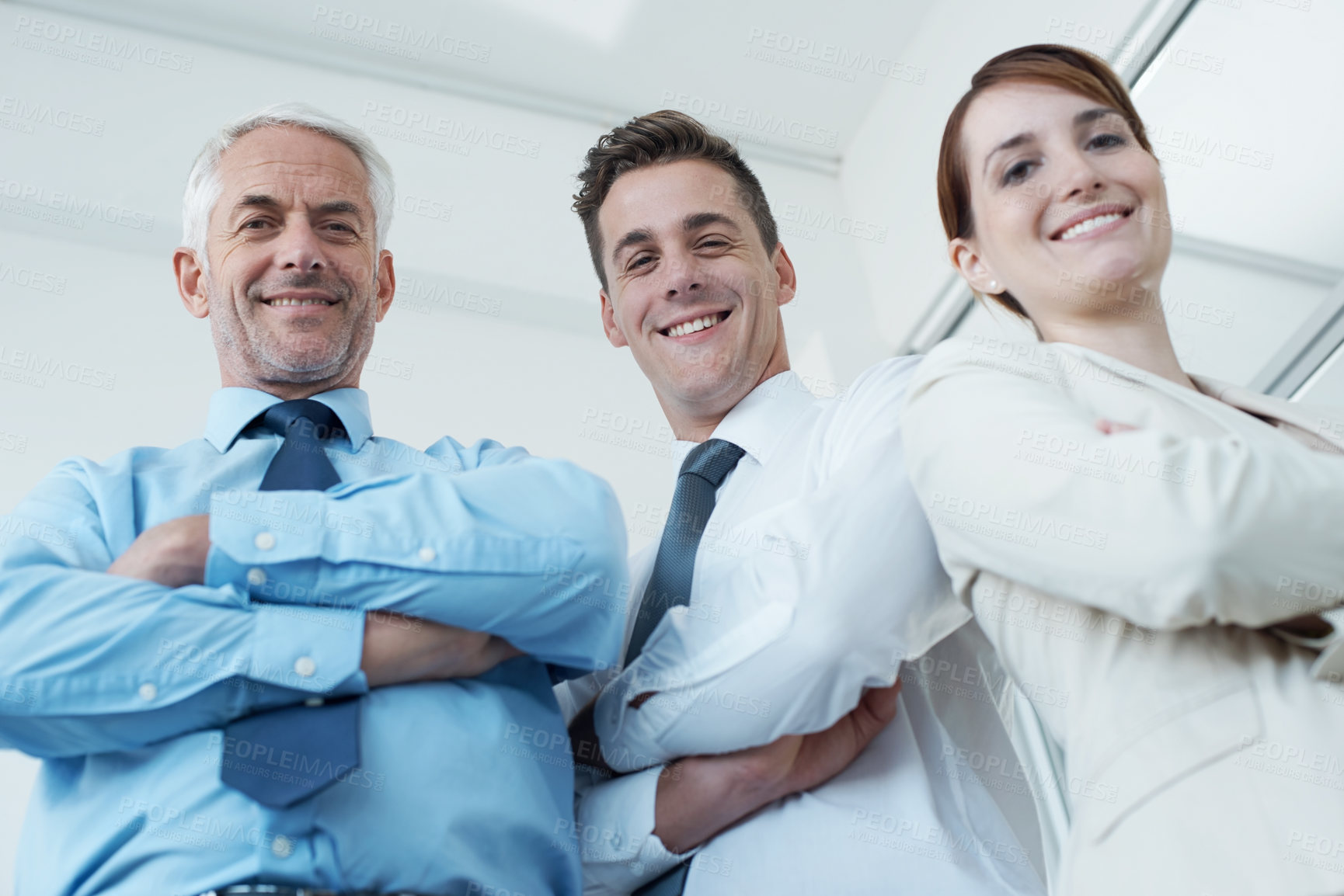 Buy stock photo Pride, crossed arms and portrait of business people in office with positive, good and confident attitude. Happy, smile and team of lawyers in meeting for collaboration in workplace from below.
