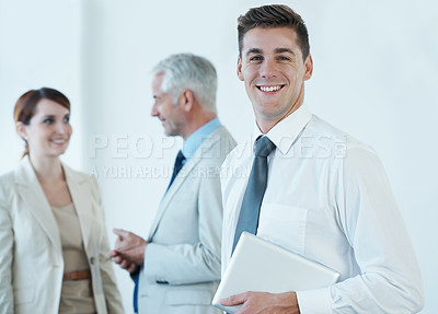 Buy stock photo Portrait, smile and business man with tablet in office for start of corporate career as professional intern. Technology, trust and happy young employee in boardroom of workplace with colleagues