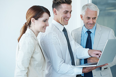 Buy stock photo Business people, laptop and discussion on idea in office, communication and meeting in workplace. Coworkers, collaboration and happy with research on internet, planning and teamwork on technology