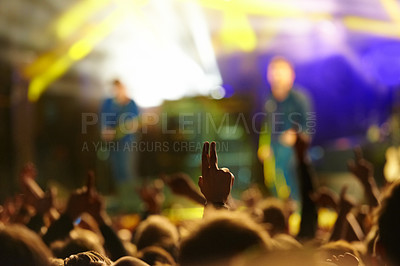 Buy stock photo Concert, audience and hand or sign with band for music festival, night club and cheering with energy. Disco, party and people with light, gesture and performance at rock event with entertainment 